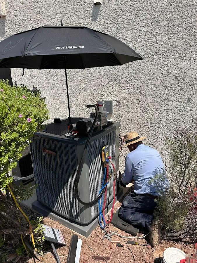 HVAC technician performing outdoor AC maintenance in Haverford