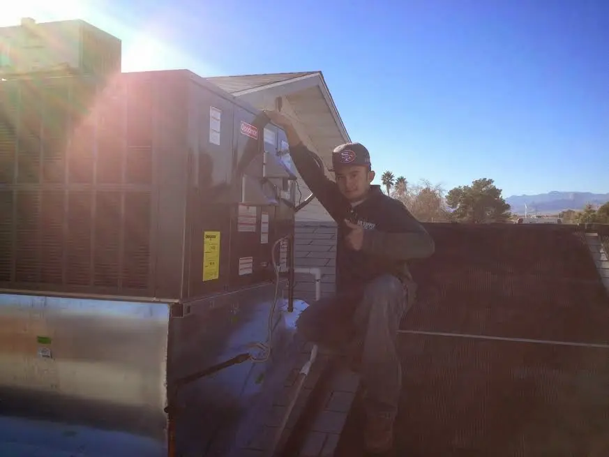 HVAC technician performing Boiler Repair on a rooftop unit in Haverford